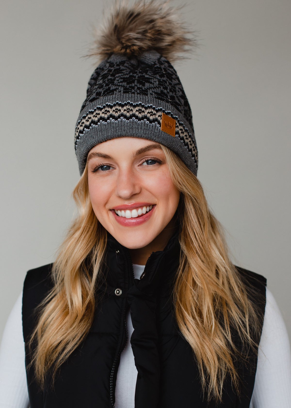 GREY, BLACK, AND TAN PATTERNED POM HAT