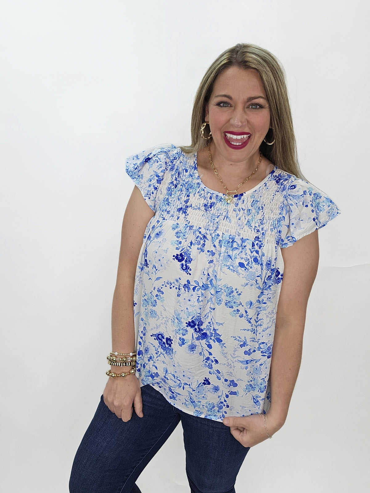 BLUE/WHITE FLORAL FLUTTER SLEEVE WITH SMOCKED NECKLINE WOVEN TOP